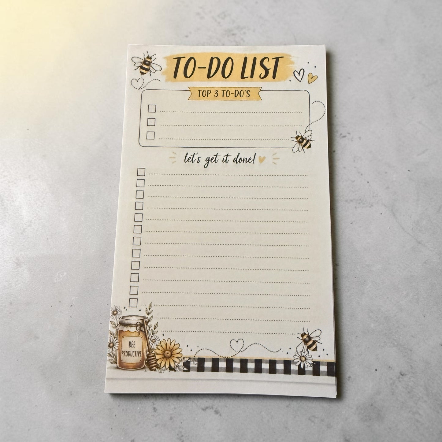 Titch of Everything bee themed daily to-do list notepad with floral accents and a Bee Productive jar illustration.