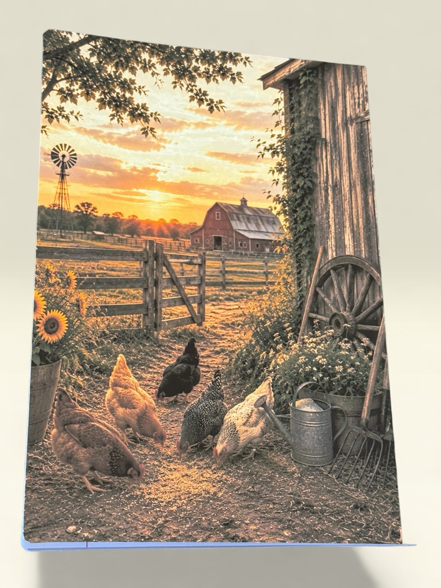 Titch of Everything composition notebook featuring a rustic farm scene with chickens, a red barn, and sunset.