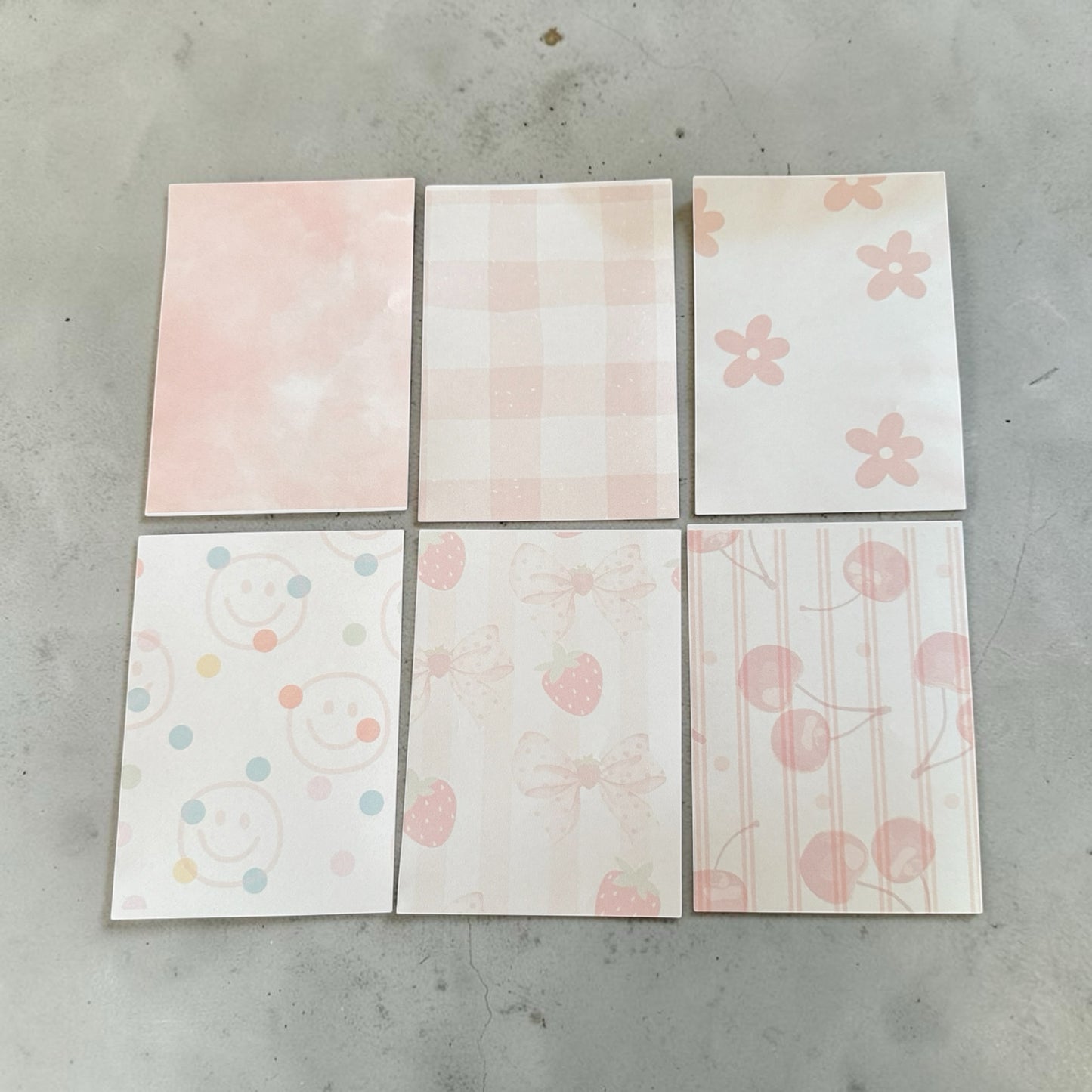 Titch of Everything pastel memo pad set featuring strawberry, bow, smiley face, and floral patterns on smooth paper.